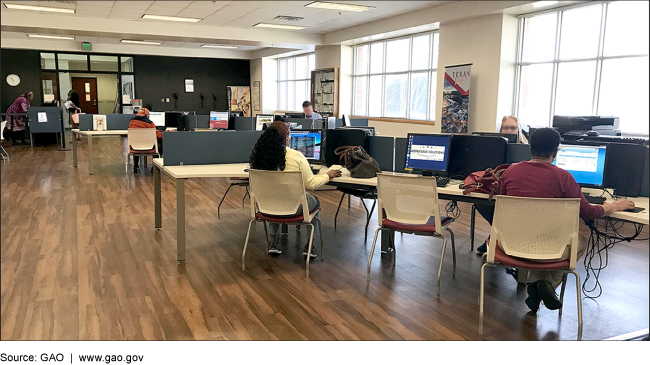 People using computers at a resource center. 