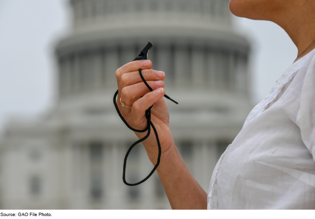 Person with whistle by the Capitol dome.