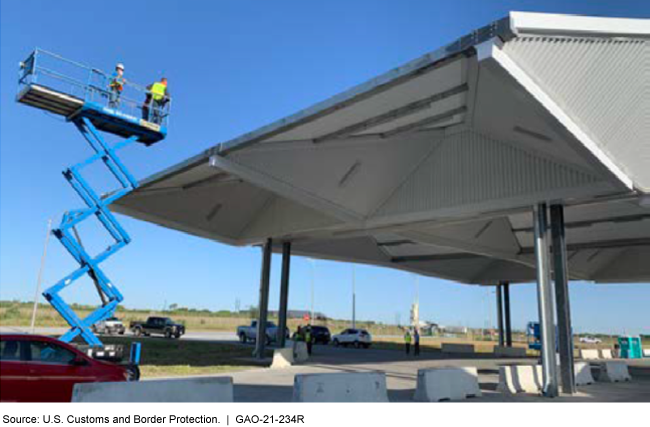 Two people standing on an aerial work platform. 