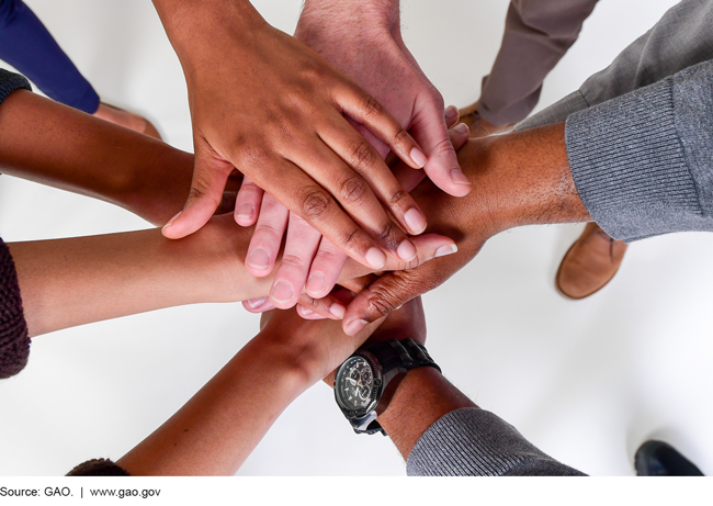 An aerial view of a bunch of hands on top of each other.