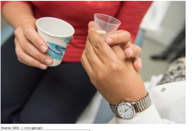 Picture of a doctor giving a patient medication. 