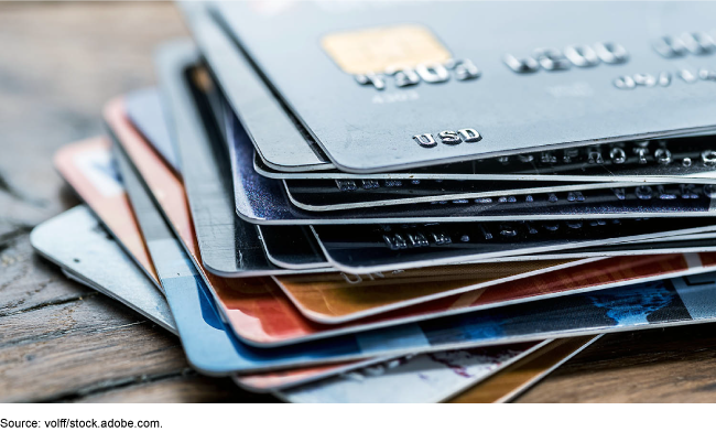 An image of a stack of credit cards on a table. 