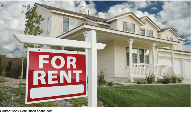 A single-family home with a 'For Rent' sign in the front yard.