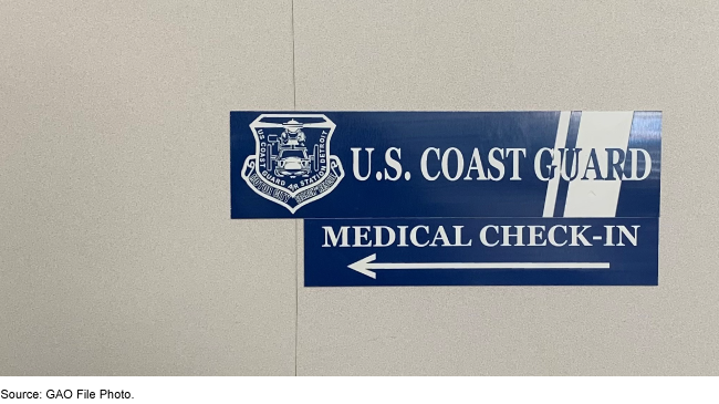 sign on a wall pointing to a U.S. Coast Guard medical check-in