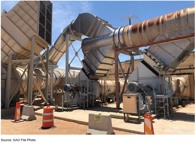 A series of gray-colored ventilation ducts situated above-ground.