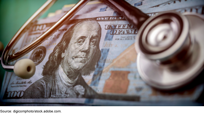 A stack of 100-dollar bills with a stethoscope on top. A stack of 100-dollar bills with a stethoscope on top.