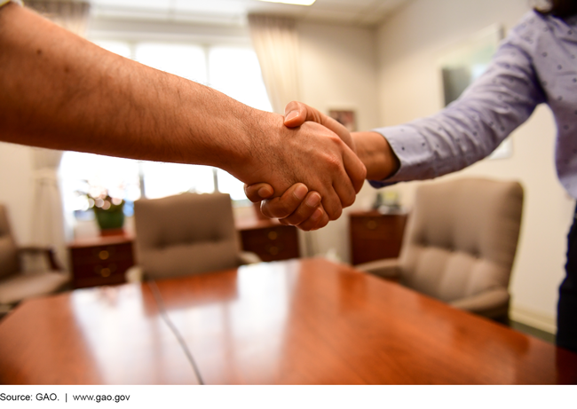 This is a photo of two hands in a handshake.