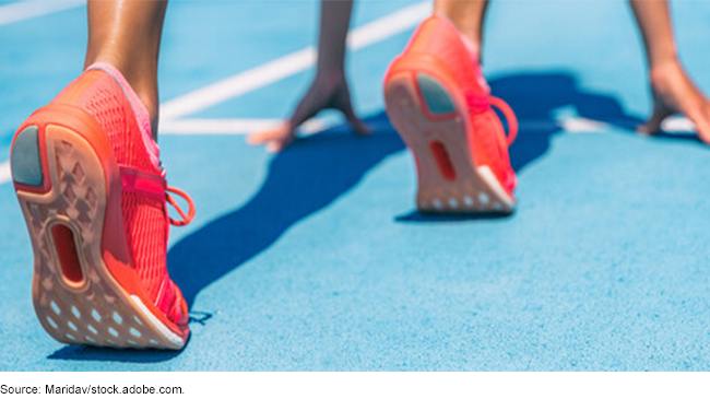 A person at a race starting line about to run. 