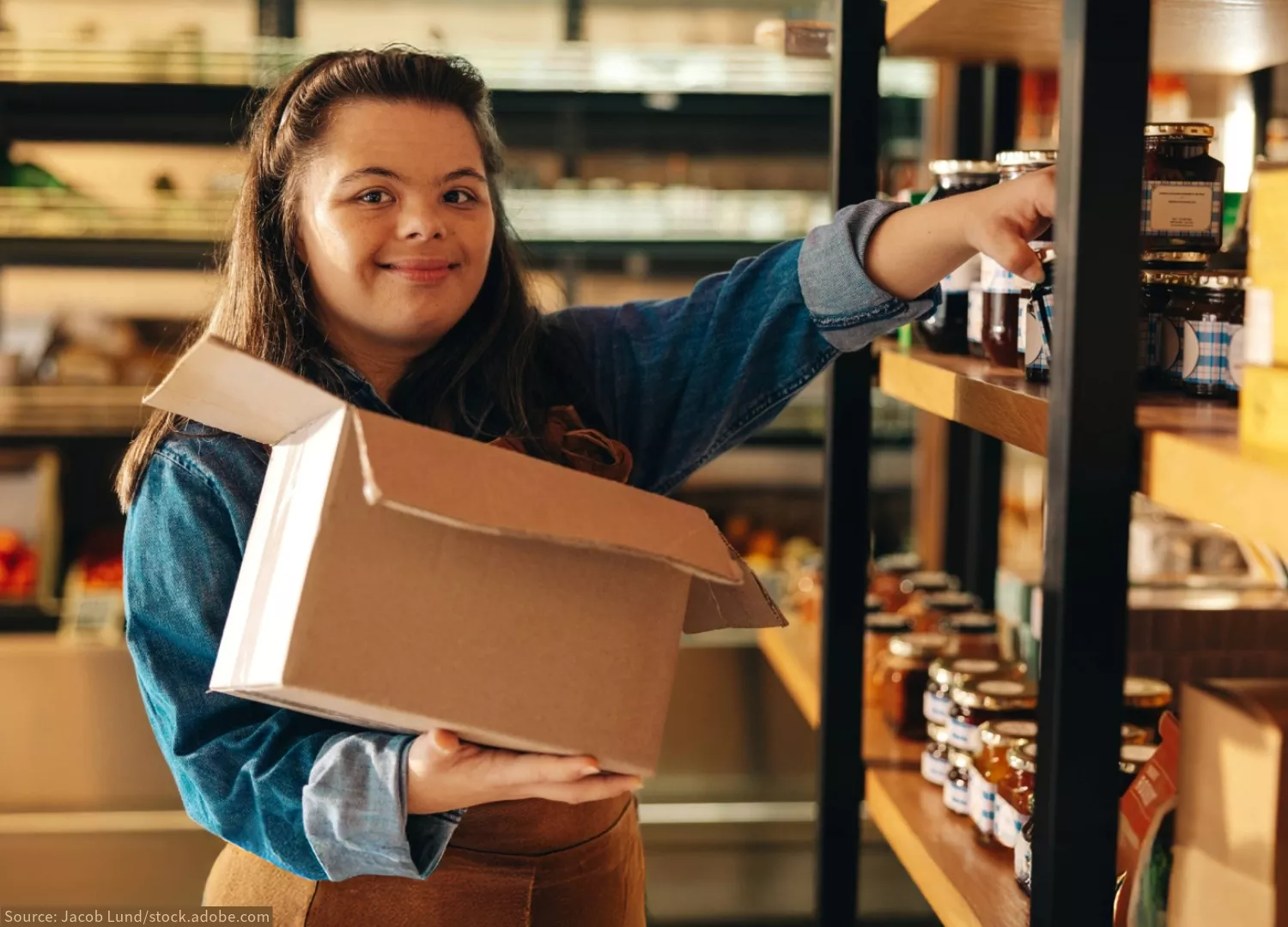 A grocery store worker with Down syndrome stocking shelves.
