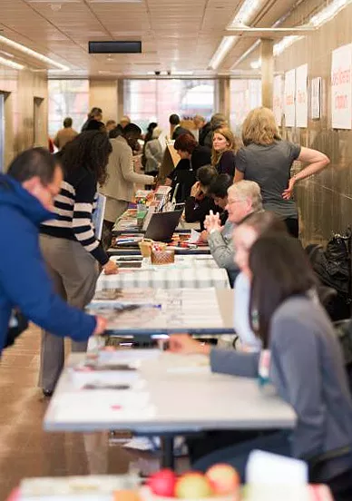 Staff attending the 2014 CFC Fair setup in the hallway of GAO's headquarters building