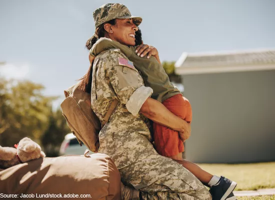 Military woman hugging child