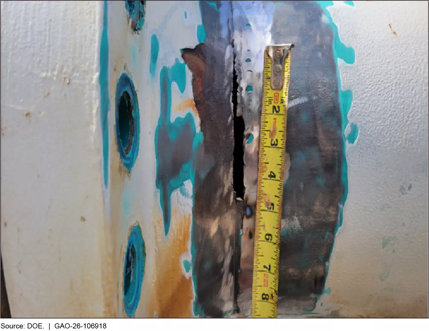 A leaking water pipe with a tape measurer to show the extent of damage.