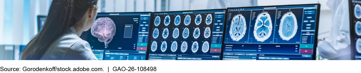 A female doctor looking at brain scans on computer monitors.