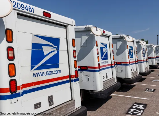 A photo of United States Postal Service vehicles.