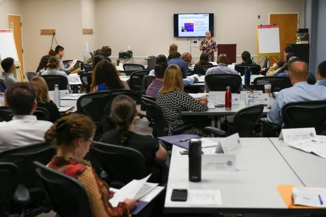 PDP staff attend training in a large conference room