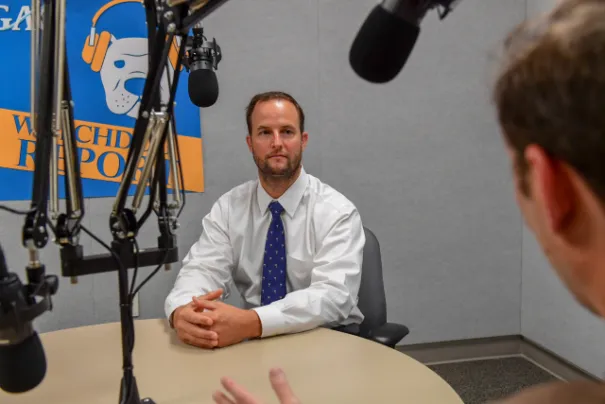 Photo of Chris Currie, a GAO Homeland Security and Justice Director, while being interviewed in GAO's podcast studio