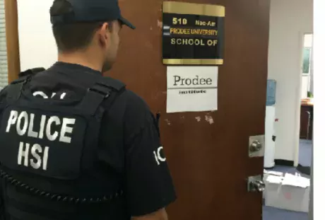 Photo of a police officer entering an office at a school.