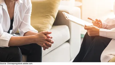Stock image showing two people--a counselor and someone receiving counseling. 