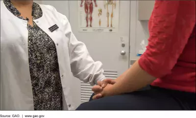 Photo of a nurse or medical practitioner and a patient.