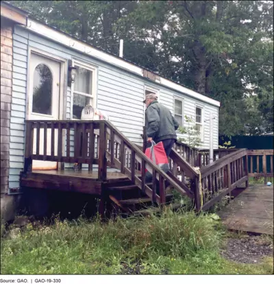 Photo of volunteer delivering a week's worth of meals in rural Maine.