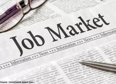 Newspaper-style document with the banner "Job Market" written on top and a pen laying across it.