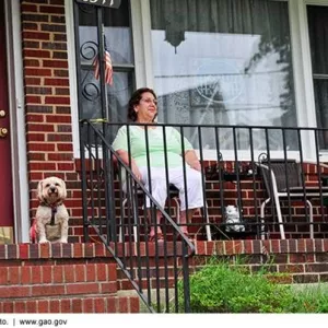 Photo of an older woman sitting on her porch.