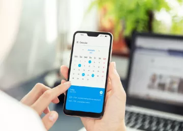 A person taps the calendar on their phone