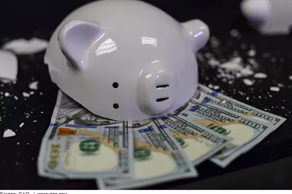 Piggy Bank smashed with money falling out. 