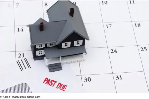 Illustration of a toy house on top of a calendar showing an overdue bill