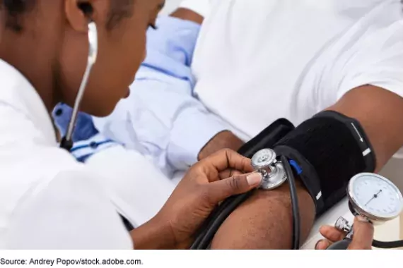 Doctor taking patients blood pressure 