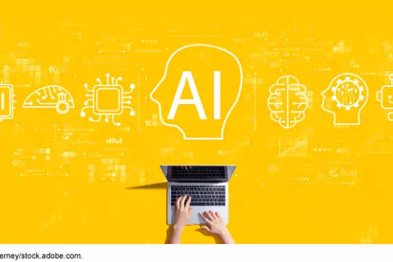 Graphic illustrating Artificial Intelligence--a persons hands are typing on a keyboard. Above that image are small icons for different applications. The center one says AI.