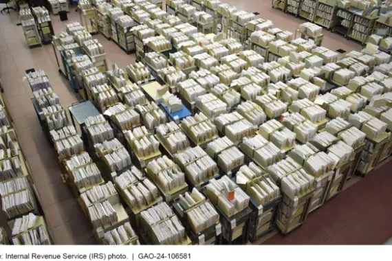 Photo showing tax documents (rows of documents on roller carts) in the IRS's Kansas City, MO processing center, May 2023