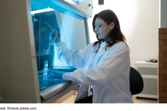 A scientist working in a biosafety cabinet. 