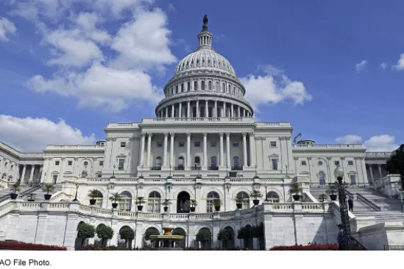 U.S. Capitol building under a bright blue sky. 