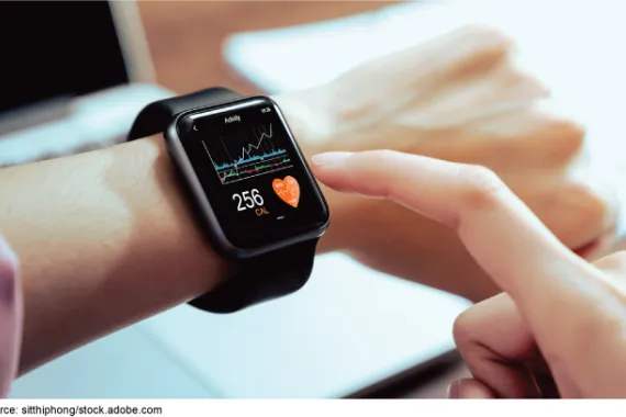 A closeup of a smartwatch on someone's wrist displaying heartrate and other data.