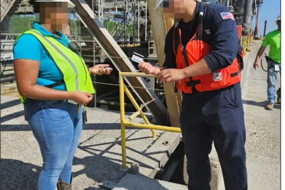 Coast Guard inspector checking credential