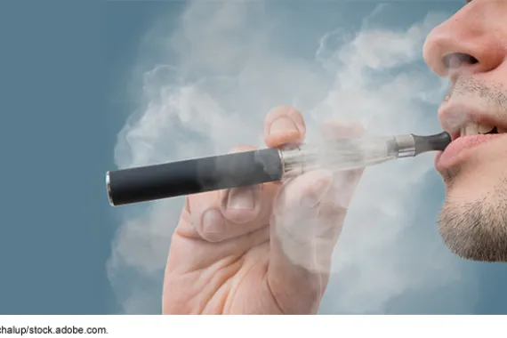 A person using an e-cigarette.