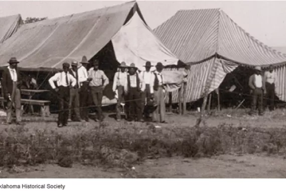 A group of people standing outside of a tent  AI-generated content may be incorrect.