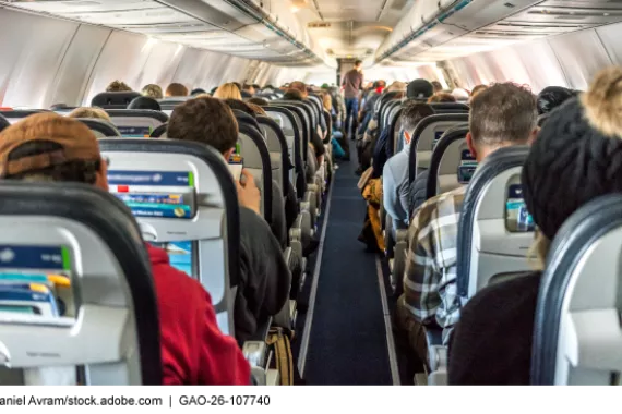 Passengers sitting in the cabin of a commercial airplane.