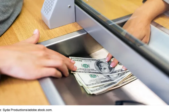 Bank teller dispensing money.