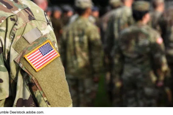 Service member with flag on shoulder.  