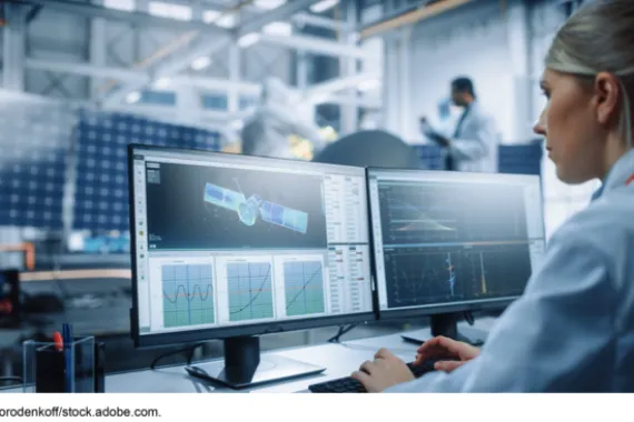 Woman working on a satellite on a computer.