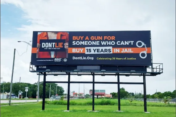 A roadside billboard with text telling people that the sentence for lying for the other guy is 15 years in jail.