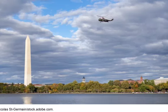 A military helicopter flies past the Washington Monument in Washington, D.C.