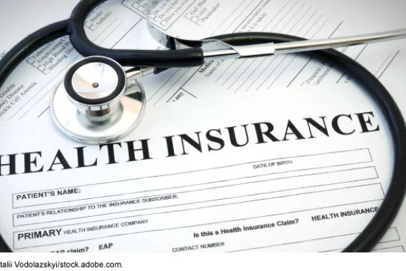 A blank form titled Health Insurance encircled by a stethoscope.