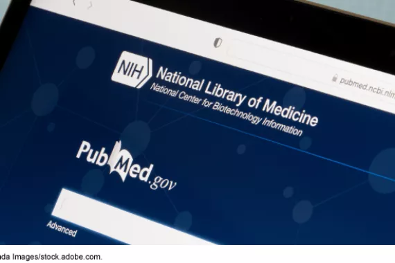 A laptop's web browser visiting the PubMed landing page on the National Institutes of Health website. 