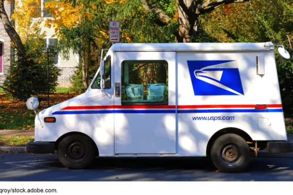 U.S. Postal Service truck parked along a curb