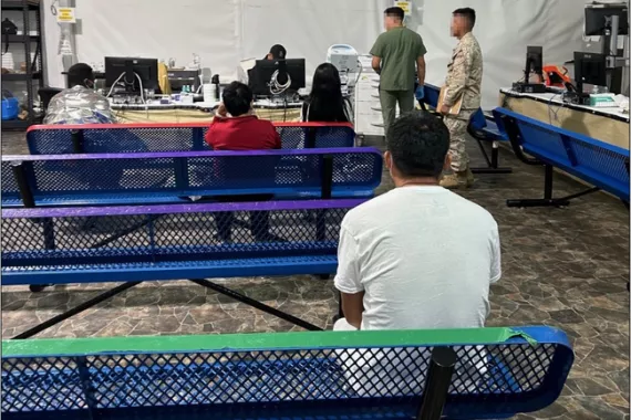 Individuals in CBP custody sitting on benches waiting to see a contracted medical provider. 