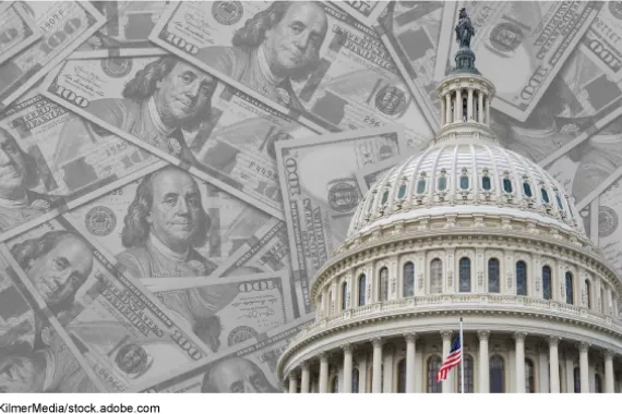 The U.S. Capitol building in front of a background of $100 bills.