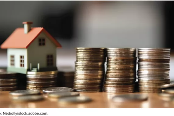 Stock image of a house and coins.
